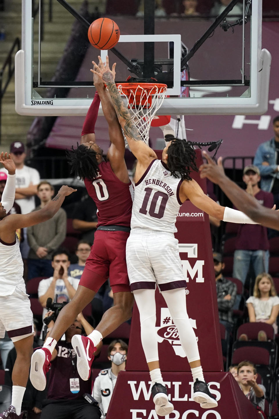 Texas A&M forward Ethan Henderson (10) blocks a shot by Arkansas guard Stanley Umude (0) during the second half of an NCAA college basketball game Saturday, Jan. 8, 2022, in College Station, Texas. (AP Photo/Sam Craft)