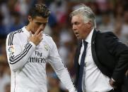 Real Madrid's Cristiano Ronaldo (L) receives instructions from his coach Carlo Ancelotti during their Spanish Super Cup first leg soccer match against Atletico Madrid at the Santiago Bernabeu stadium in Madrid August 19, 2014. REUTERS/Juan Medina