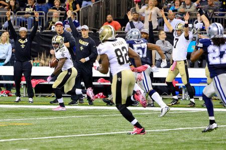 Oct 4, 2015; New Orleans, LA, USA; New Orleans Saints running back C.J. Spiller (28) carries the ball to score an 80 yard game winning touchdown during overtime against the Dallas Cowboys at the Mercedes-Benz Superdome. Derick E. Hingle-USA TODAY Sports