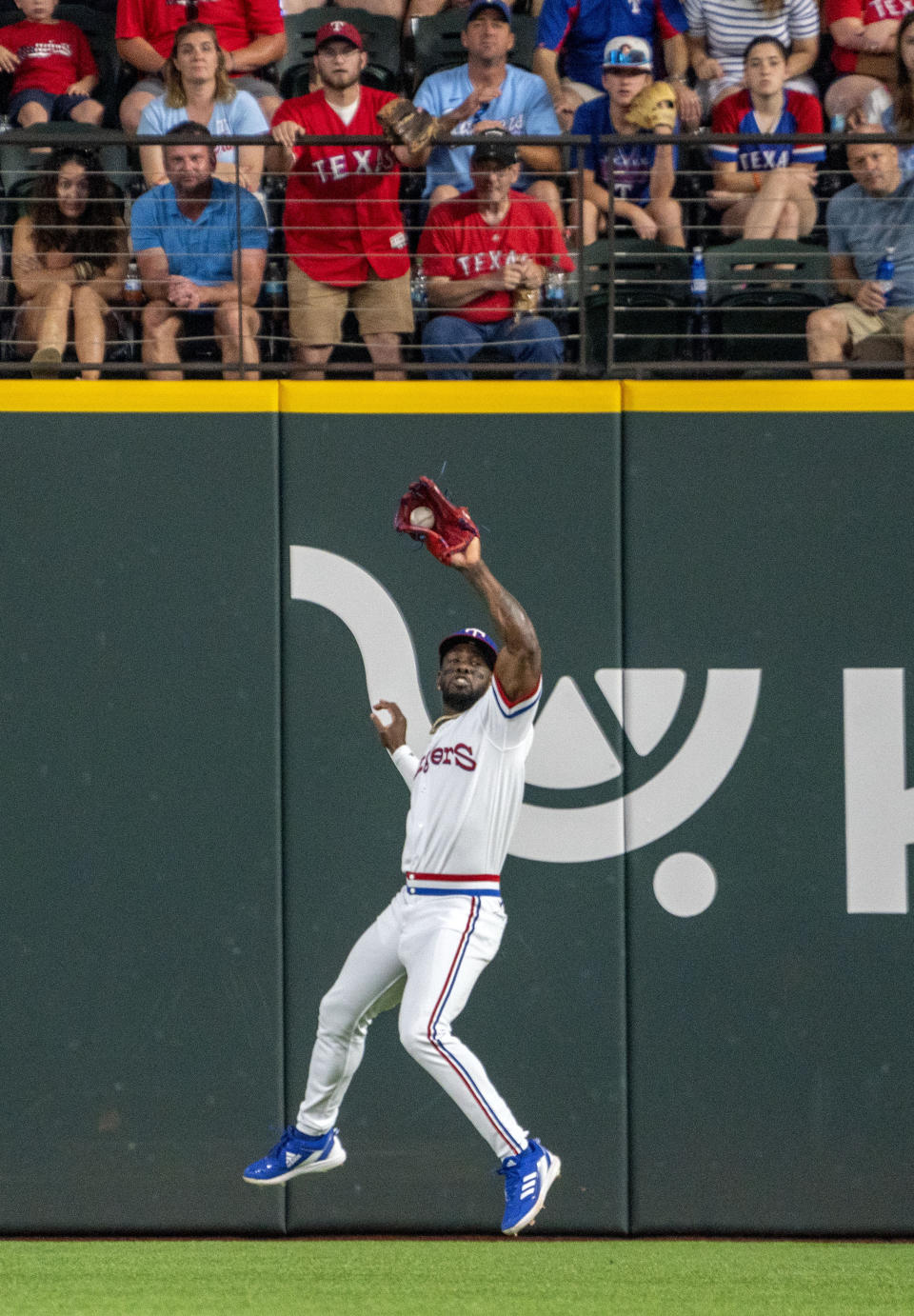 Texas Rangers right fielder Adolis Garcia catches a line drive by Washington Nationals' Lane Thomas during the second inning of a baseball game Saturday, June 25, 2022, in Arlington, Texas. (AP Photo/Jeffrey McWhorter)