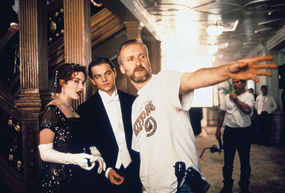 Titanic stars Kate Winslet and Leonardo DiCaprio with director James Cameron on set.