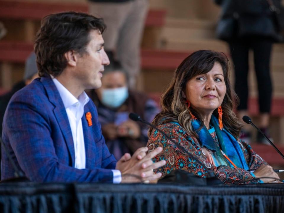 Prime Minister Justin Trudeau and Tk'emlups Kúkpi7 Chief Rosanne Casimir speak during an event outside the former Kamloops Indian Residential School in Kamloops, B.C. (Ben Nelms/CBC - image credit)