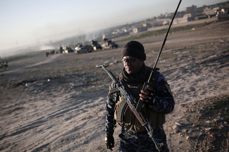 A member of the Iraqi federal police holds a radio in the town of Hamam al-Alil, Sunday Feb. 19, 2017. U.S.-backed Iraqi forces launched a large-scale military operation to dislodge Islamic State militants from the western half of Mosul city on Sunday. (AP Photo/Bram Janssen)