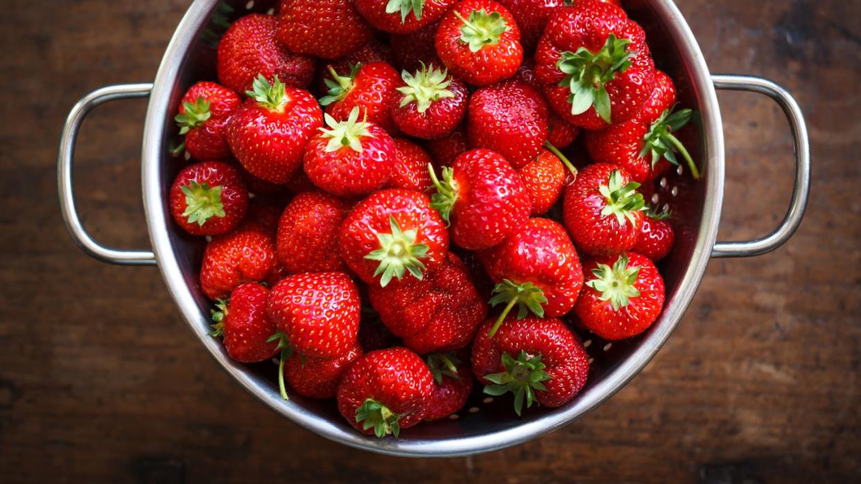 colander full of ripe strawberries