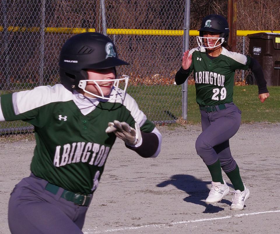 Abington's Callie Pineau (L) bats in Ava DiPietro (R) to advance their lead on Walpole later in the game on Monday, April 3, 2023. 