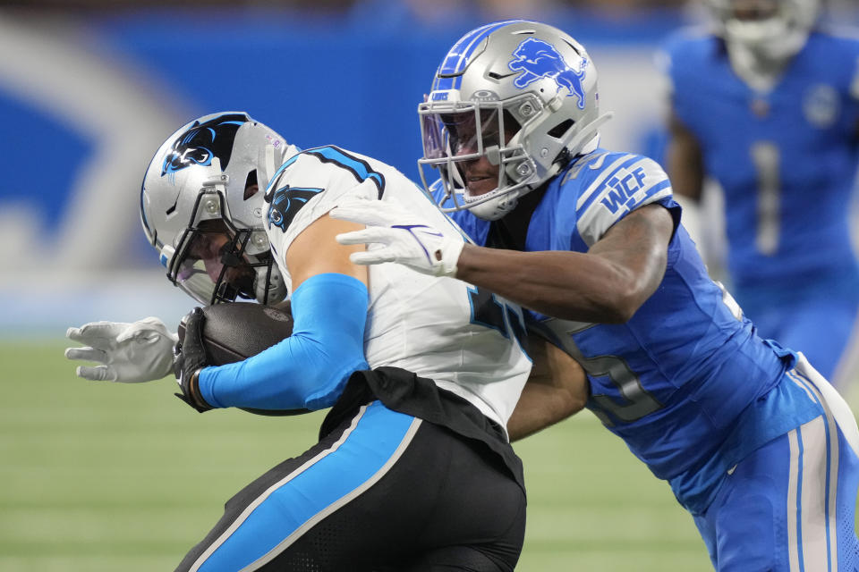 Carolina Panthers wide receiver Adam Thielen is tackled by Detroit Lions cornerback Will Harris in the first half of an NFL football game in Detroit, Sunday, Oct. 8, 2023. (AP Photo/Carlos Osorio)