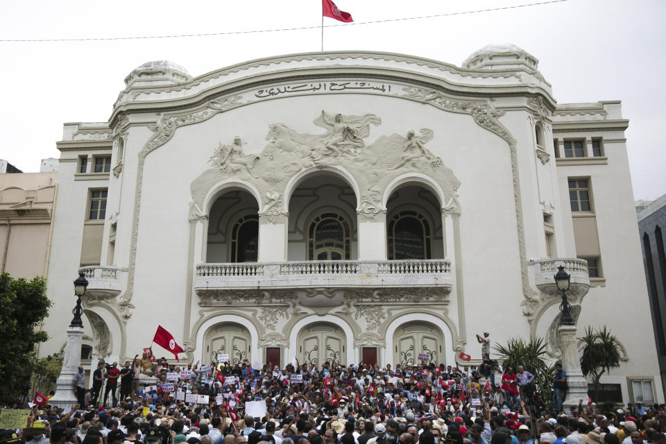 Tunisian demonstrators gather outside the Municipal Theatre of Tunis during a protest against Tunisian President Kais Saied, Saturday, Sept. 18, 2021. In July Tunisian President Kais Saied fired the country's prime minister and froze parliament's activities after violent demonstrations over the country's pandemic and economic situation. The movement made by Saied was considered by his opponents as a coup. (AP Photo/Riadh Dridi)