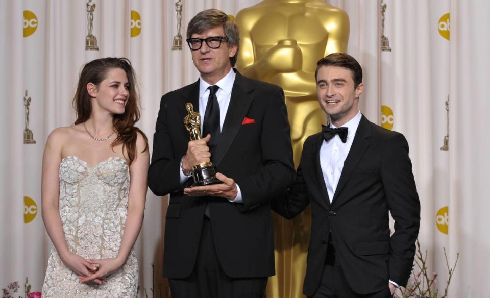 Presenter Kristen Stewart, left, and Daniel Radcliffe pose with Rick Carter with his award for best production design for “Lincoln” during the Oscars at the Dolby Theatre on Sunday Feb. 24, 2013, in Los Angeles. Carter will receive the King Vidor Award at the Fremont Theater in San Luis Obispo on April 29, 2023, as part of the San Luis Obispo International Film Festival.