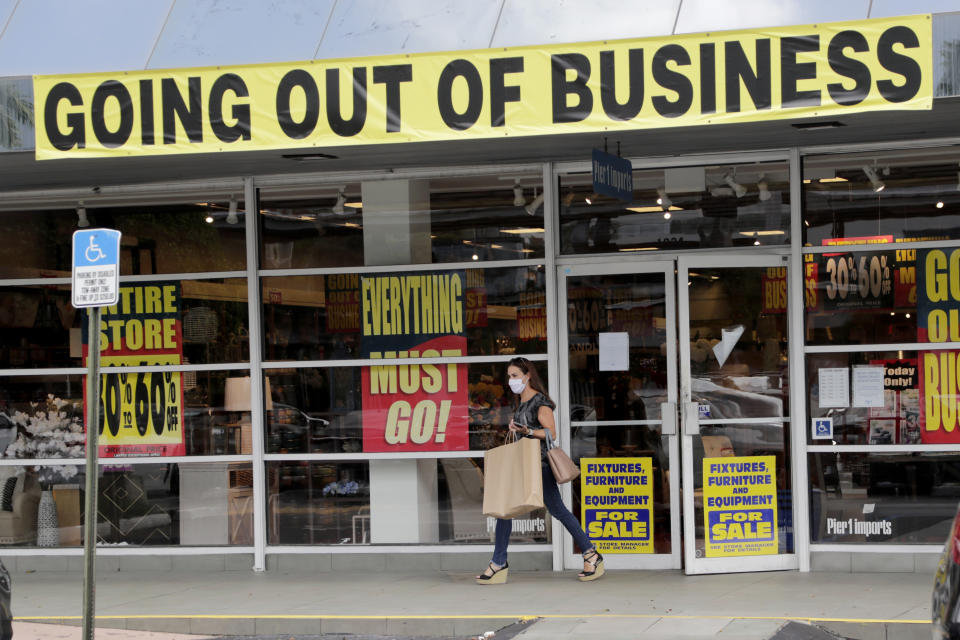 FILE - In this Aug. 6, 2020, file photo, a customer leaves a Pier 1 retail store, which is going out of business, during the coronavirus pandemic in Coral Gables, Fla. The number of laid-off workers applying for unemployment aid fell below 1 million last week for the first time since the pandemic intensified five months ago, yet still remains at a high level. (AP Photo/Lynne Sladky, File)