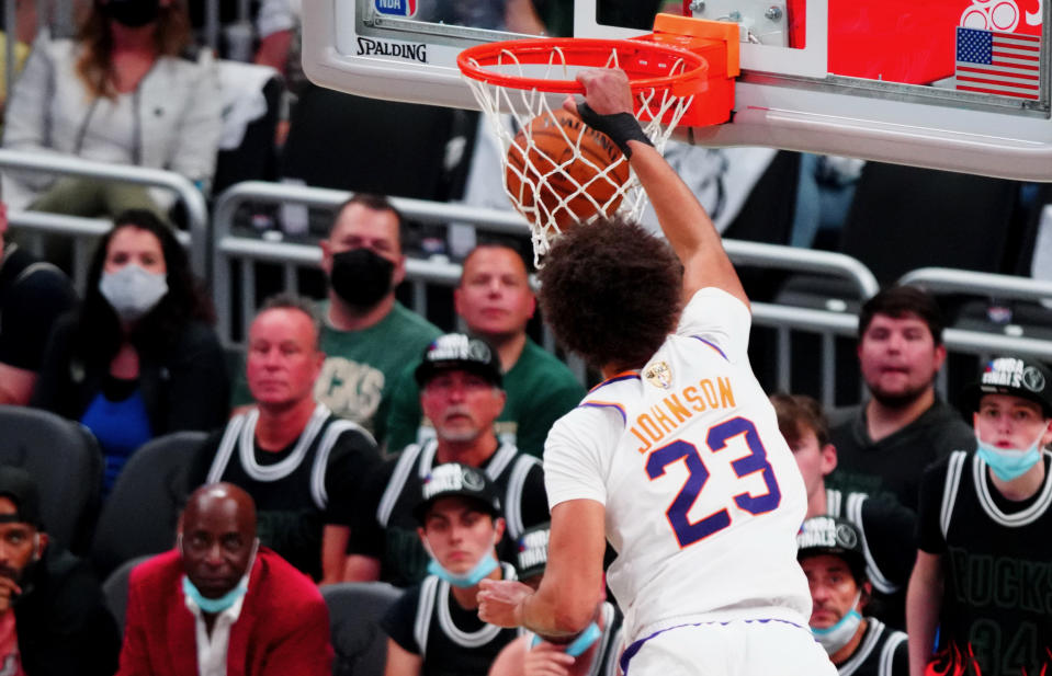 Jul 11, 2021; Milwaukee, Wisconsin, USA; Phoenix Suns forward Cameron Johnson (23) dunks over Milwaukee Bucks forward P.J. Tucker (17) during game three of the 2021 NBA Finals at Fiserv Forum. Mandatory Credit: Mark J. Rebilas-USA TODAY Sports - 16396223