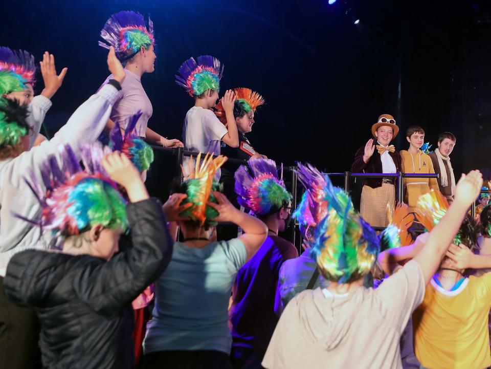 The Oompa Loompas wave goodbye to Willy Wonka (played by Daisy Gemmer), Charlie (played by Miles Borer) and Grandpa Joe (played by Riley Franco) during rehearsal for Central Kitsap School District's summer musical at the CKHS Auditorium on Friday, Aug. 5, 2022.