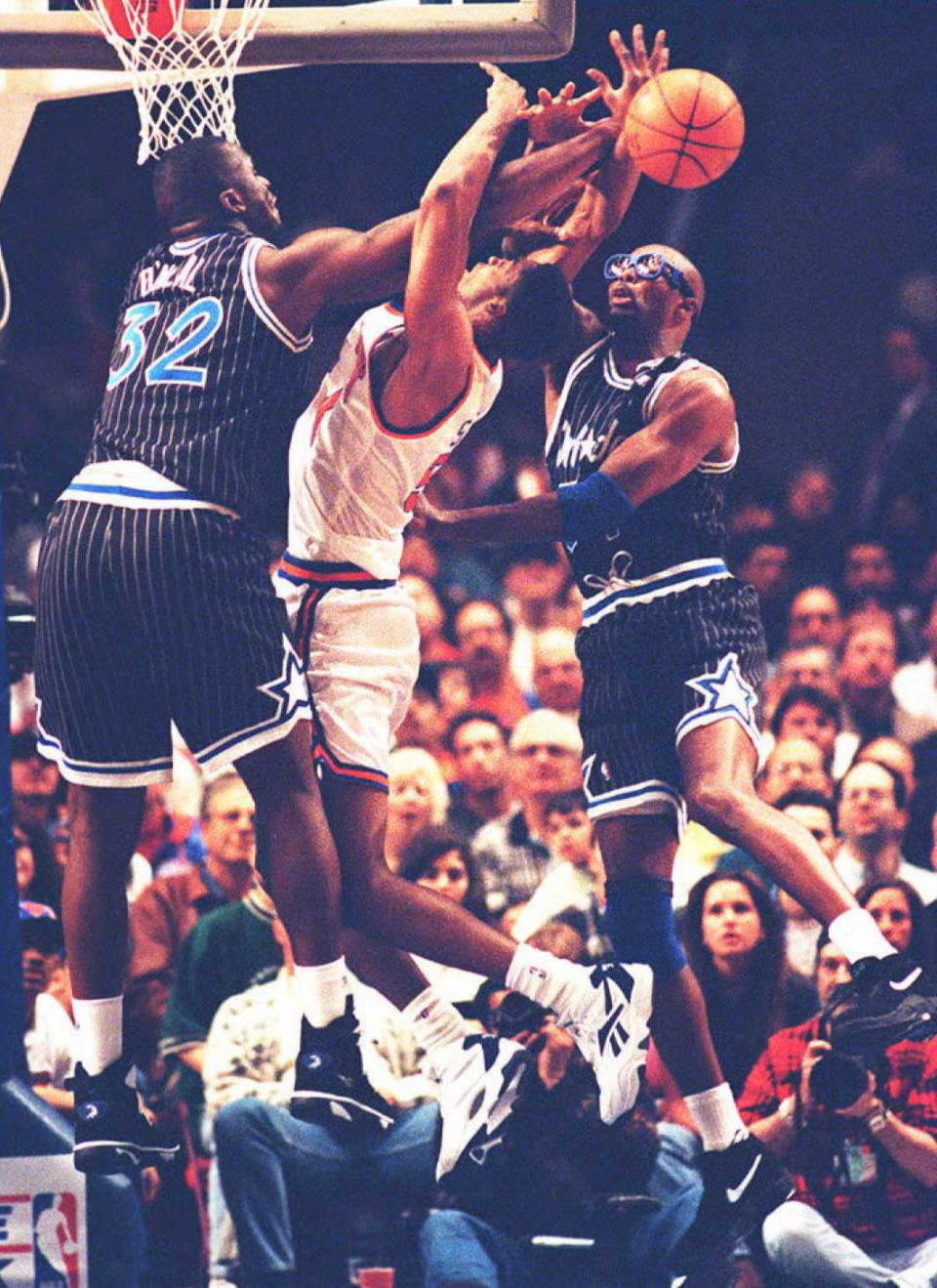 New York Knicks' Charles Smith is fouled by Shaquille O'Neal as the Magic's Horace Grant defends in the first quarter of the final regular season game for these two teams. (HENNY RAY ABRAMS/AFP/Getty Images)