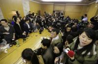 Journalists wait in a conference room for a news conference regarding the missing Malaysian Airlines flight MH370, at a hotel in Beijing March 8, 2014. The Malaysia Airlines flight carrying 227 passengers and 12 crew from Kuala Lumpur to Beijing lost contact with air traffic controllers early on Saturday, the airline said in a statement, the plane likely missing in Vietnamese airspace. Flight MH370, operating a Boeing B777-200 aircraft left Kuala Lumpur at 12.21 a.m. (1621 GMT Friday) and had been expected to land in the Chinese capital at 6.30 a.m. (2230 GMT) the same day. REUTERS/Jason Lee (CHINA - Tags: DISASTER TRANSPORT MEDIA)