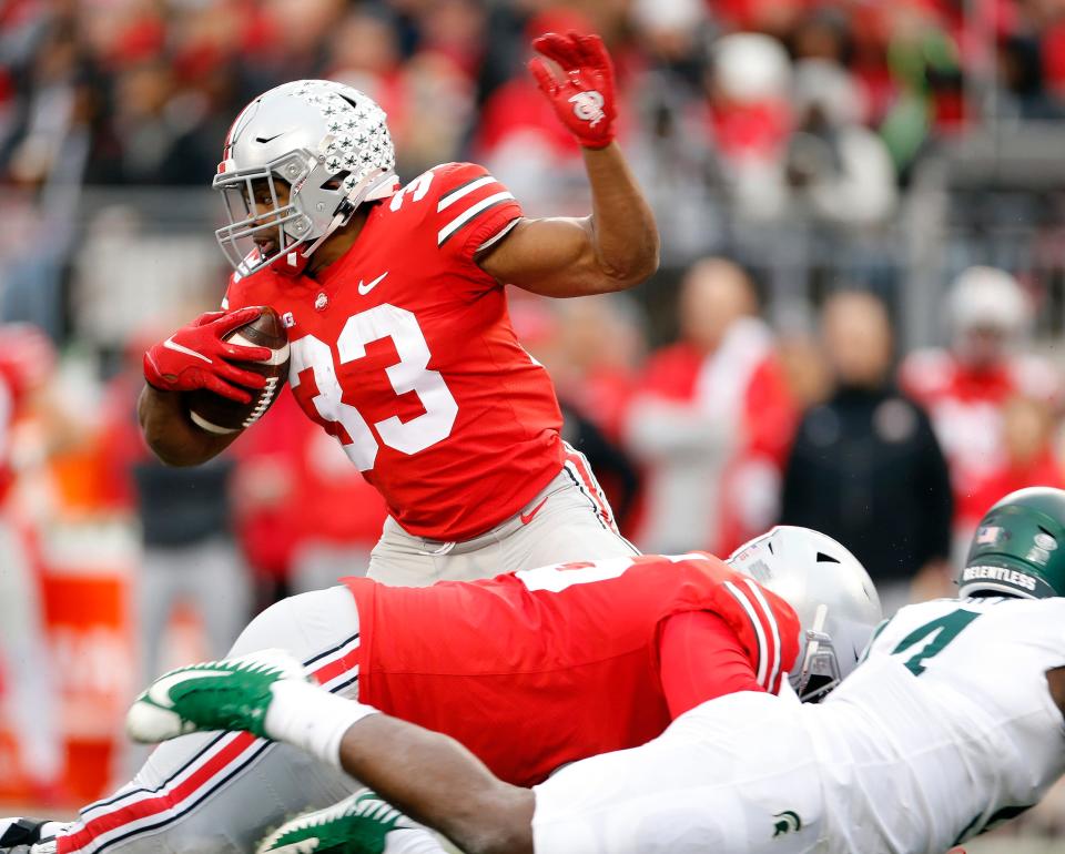 Ohio State Buckeyes running back Master Teague III (33) runs the ball against Michigan State Spartans in the fourth quarter in their NCAA College football game at Ohio Stadium in Columbus, Ohio on November 20, 2021. 