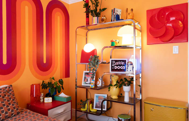 Chrome bookshelf in colorful room.