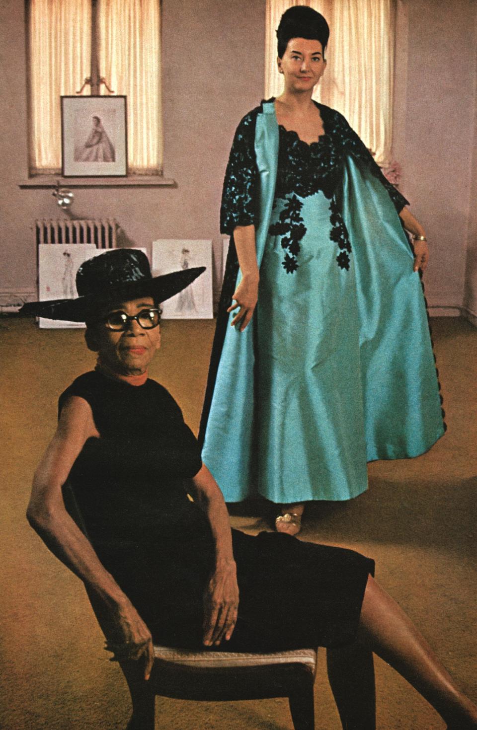 Published in Ebony magazine in 1966, Ann Lowe is seen here in the foreground with a background model, Judith Guile, modeling one of Lowe's 1960s ensembles.