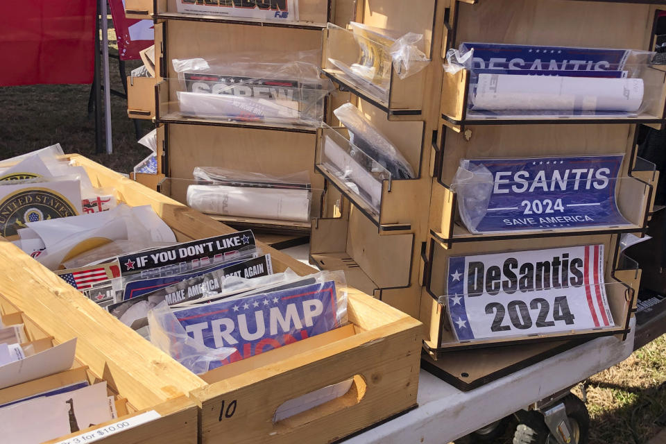 Bumper stickers supporting Florida Gov. Ron DeSantis on sale at former President Donald Trump's rally in Conroe, Texas, Saturday, Jan. 29, 2022. At Trump’s rally, there were signs of change. Next to the Trump hats, shirts and flags sat a collection of Ron “DeSantis 2024” bumper stickers. The vast majority of those interviewed at Trump’s rally enthusiastically cheered the prospect of another Trump run. But there were some who conceded that, perhaps, there might be a better option. (AP Photo/Jill Colvin)