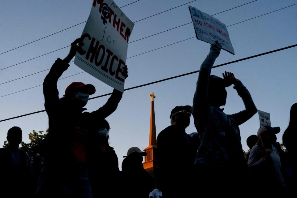 Pro-choice demonstrators march to the house of Supreme Court Justice Samuel Alito in Alexandria, Virginia, on Monday. The Senate passed a bill Monday to expand security protection to family members of Supreme Court justices.