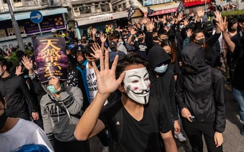 Protesters march on a street during a rally against parallel traders in Sheung Shui district on January 5, 2020 in Hong Kong, China. - Credit: Anthony Kwan