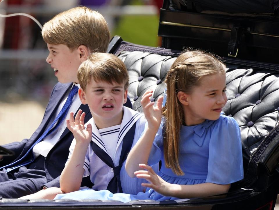 Prince George, Prince Louis and Princess Charlotte ride in the carriage procession (Andrew Matthews/PA) (PA Wire)