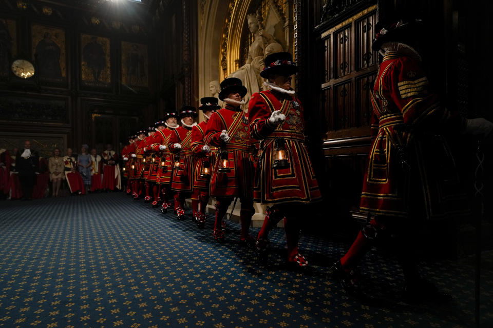 Yeomen Warders perform the ceremonial search of the Palace of Westminster prior to the State Opening of Parliament in London, Tuesday, May 10, 2022. Buckingham Palace said Queen Elizabeth II will not attend the opening of Parliament on Tuesday amid ongoing mobility issues. (AP Photo/Alastair Grant, Pool)