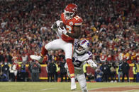 Kansas City Chiefs wide receiver Byron Pringle (13) catches a 2-yard touchdown pass ahead of Buffalo Bills safety Micah Hyde (23) during the first half of an NFL divisional round playoff football game, Sunday, Jan. 23, 2022, in Kansas City, Mo. (AP Photo/Charlie Riedel)