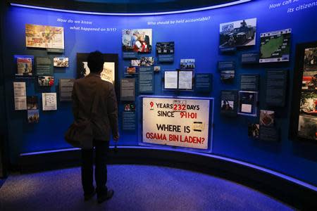 A man stands in the historical exhibition section of the National September 11 Memorial & Museum during a press preview in New York May 14, 2014. REUTERS/Shannon Stapleton