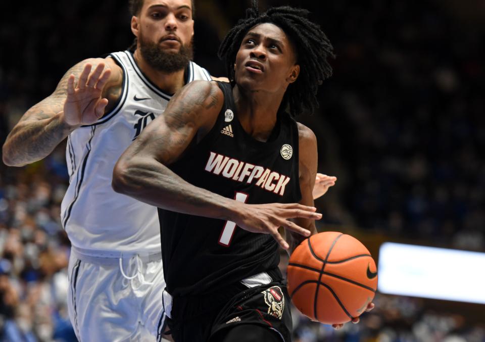 N.C. State guard Dereon Seabron drives past Duke forward Theo John, back, during a January game at Cameron Indoor Stadium in Durham.