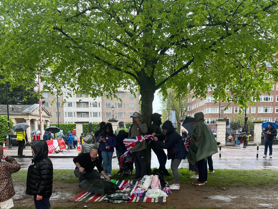 People tried to shelter from the rain under trees.