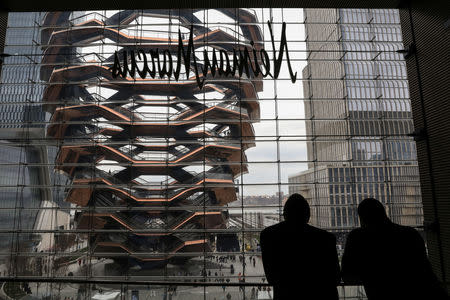 A large public art sculpture called 'The Vessel,' made up of 155 flights of stairs, is seen from inside the Shops during the grand opening of the The Hudson Yards development, a residential, commercial, and retail space on Manhattan's West side in New York City, New York, U.S., March 15, 2019. REUTERS/Brendan McDermid