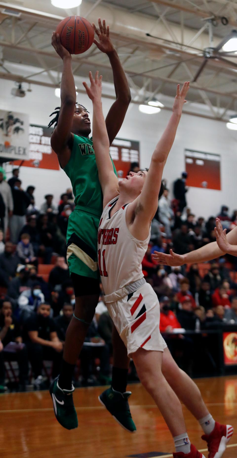 Western’s Julius Edmonds makes a bucket over Pleasure Ridge Park’s Chase Fraire.Feb. 18, 2022