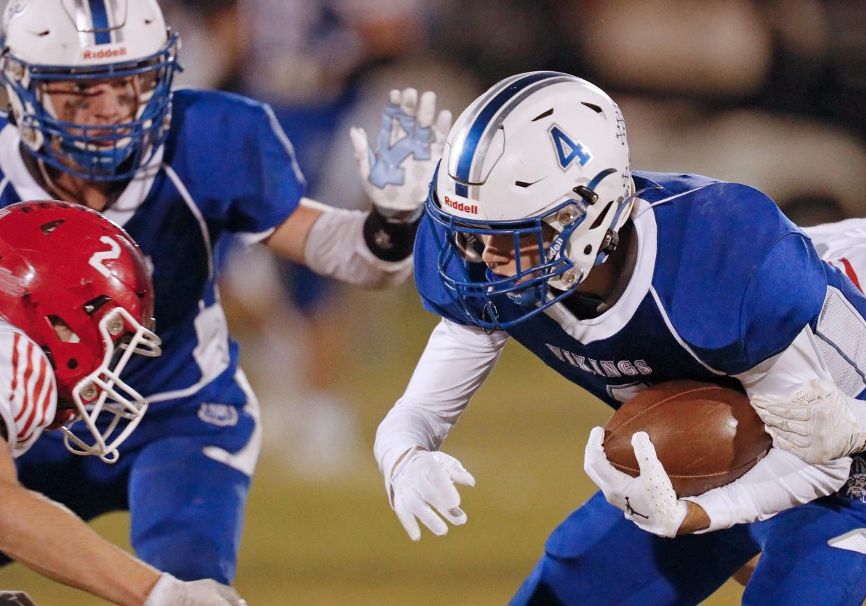 Dundee's Matt Atkinson braces for a hit from a Clinton tackler Friday night. The Vikings fell 34-7 for their first loss of the season.