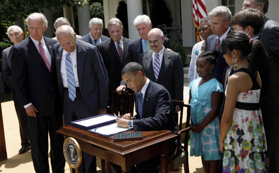 FILE - In this Monday, June 22, 2009 file photo, President Barack Obama, joined by members of Congress and others, signs the Family Smoking Prevention and Tobacco Control Act, during a ceremony in the Rose Garden of the White House in Washington. “The decades-long effort to protect our children from the harmful effects of smoking has finally emerged victorious,” Obama declared in a speech before signing the measure into law. (AP Photo/Pablo Martinez Monsivais)