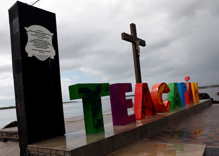 A general view shows a sign at the waterfront in the town of Teacapan near the southern tip of Sinaloa state after Hurricane Willa hit Mexico October 24, 2018. Picture taken October 24, 2018 . REUTERS/Henry Romero.