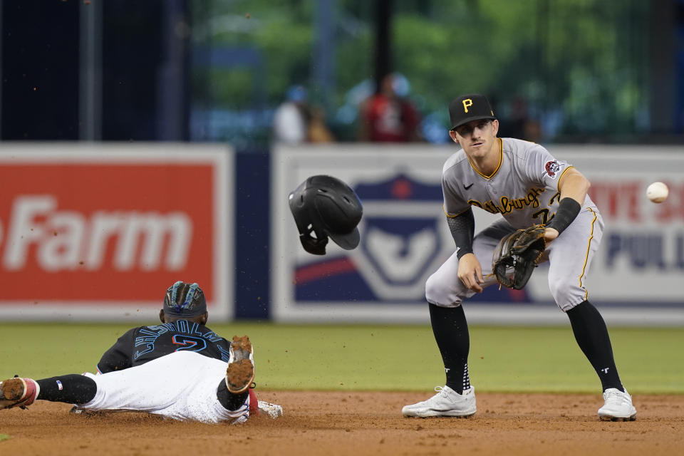 Miami Marlins' Jazz Chisholm Jr. (2) advances to second base on an error on a pickoff throw to first as Pittsburgh Pirates shortstop Kevin Newman (27) waits for the throw during the first inning of a baseball game, Saturday, Sept. 18, 2021, in Miami. (AP Photo/Marta Lavandier)