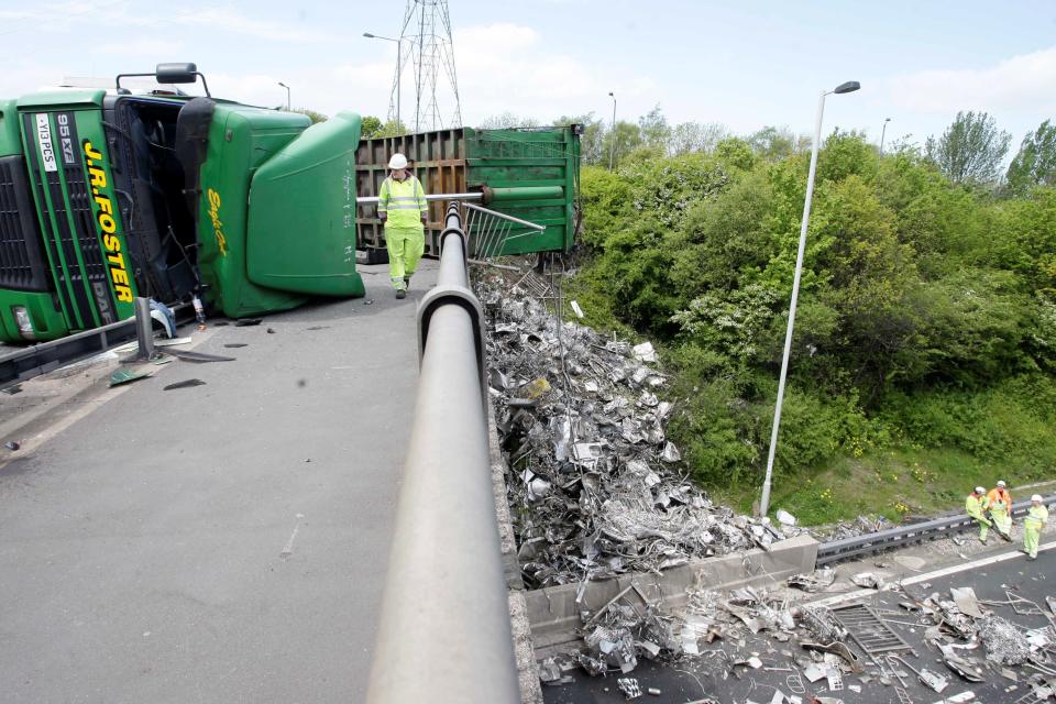 Motorists had a lucky escape when a scrap metal lorry overturned on a bridge – pouring debris on to a busy stretch of motorway below. The driver of the HGV was crossing a bridge over the M6 on Monday morning when he lost control and his vehicle tipped on its side.