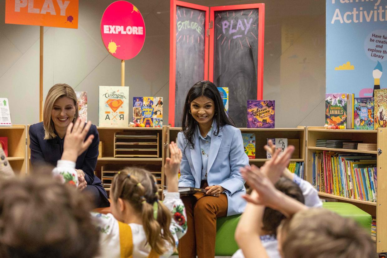 Akshata Murty, wife Britain's Prime Minster (R) and Ukraine's First Lady Olena Zelenska (L) read to Ukrainian children during a visit to The British Library in central London (POOL/AFP via Getty Images)