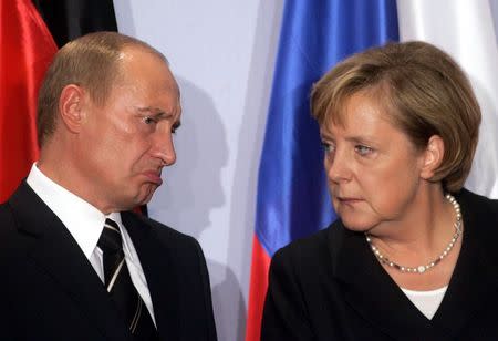 German Chancellor Angela Merkel (R) and Russian President Vladimir Putin attend a news conference during the so-called 'Petersburg Dialogue' summit between Russia and Germany in the eastern German city of Dresden in this October 10, 2006 file photo. REUTERS/Arnd Wiegmann/Files