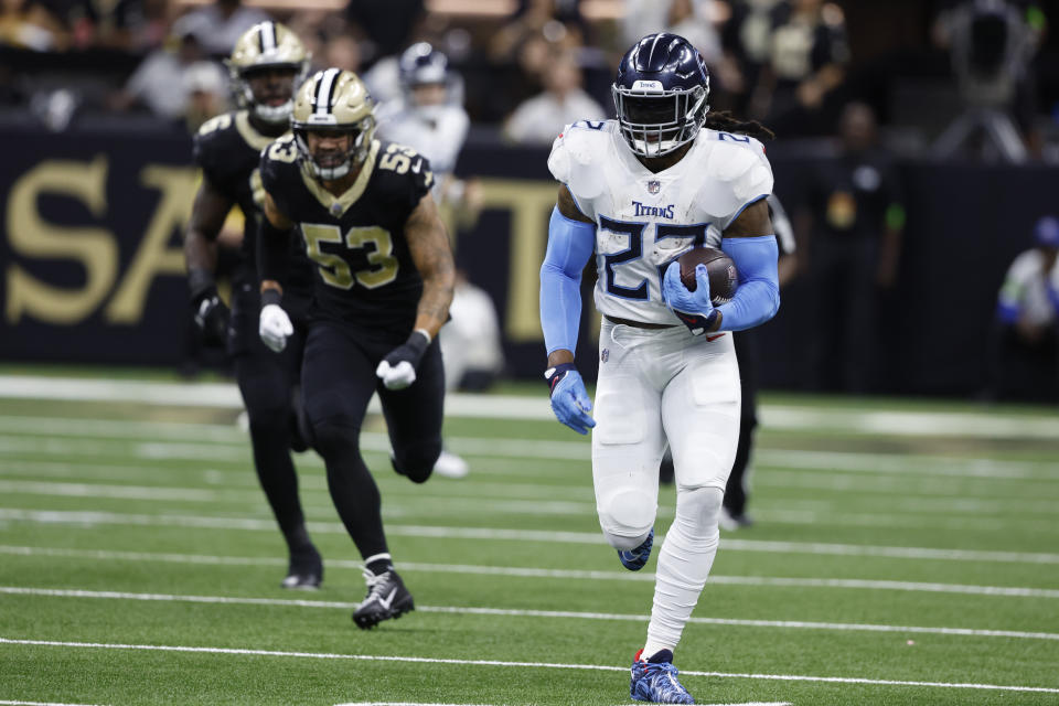 Tennessee Titans running back Derrick Henry rushes for a first down past New Orleans Saints defenders in the first half of an NFL football game in New Orleans, Sunday, Sept. 10, 2023. (AP Photo/Butch Dill)