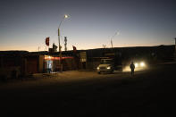 A man walks along a dusty road in San Pedro de Atacama, Chile, late evening Sunday, April 16, 2023. A 2020 report by the United Nations, said that mining has consumed 65% of water around the Atacama Salt Flat, “causing groundwater depletion, soil contamination and other forms of environmental degradation, forcing local communities to abandon ancestral settlements.” (AP Photo/Rodrigo Abd)