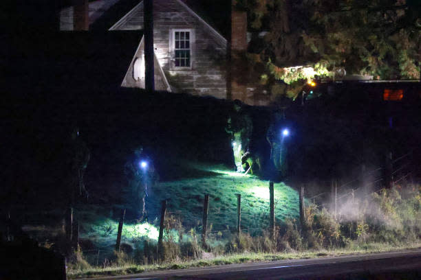 Law Enforcement officials search an area for a suspect in connection with two mass shootings on 26 October 2023 in Bowdoin, Maine (Getty Images)
