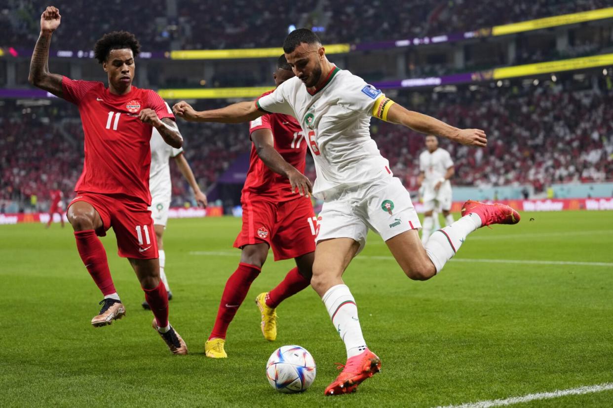 Morocco's Romain Saiss, right, clears the ball in front Canada's Tajon Buchanan during a group match on Thursday.