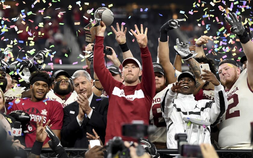 Oklahoma coach Lincoln Riley holds up the Big 12 championship trophy after beating Texas in 2018