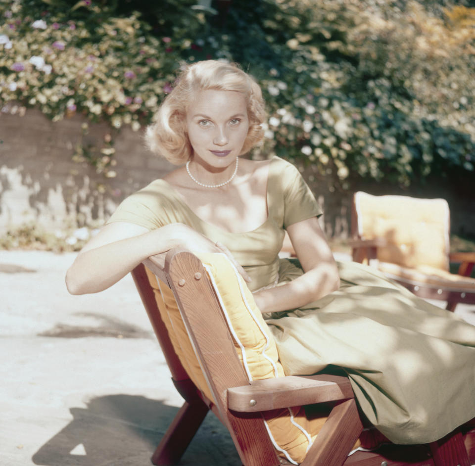 Actress Eva Marie Saint pictured seated on a sun lounger in a garden circa 1950.