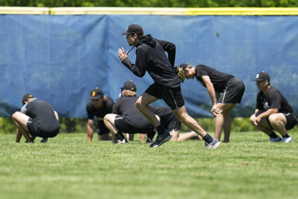Birmingham-Southern players warm up at a practice Thursday, May 30, 2024, in Kirtland, Ohio. On Friday, the Panthers will continue an unexpected, uplifting season that has captured hearts across the country by playing in the Division III World Series on the same day the liberal arts college founded on the eve of the Civil War shuts its doors. (AP Photo/Sue Ogrocki)