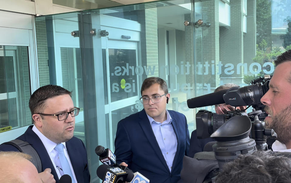 Attorney Joshua Blanchard, left, representing Barry Croft Jr., speaks with the media outside the federal courthouse in Grand Rapids, Mich., following closing arguments in the trial of Croft and Adam Fox, Monday, Aug. 22, 2022. (AP Photo/Joey Cappelletti)