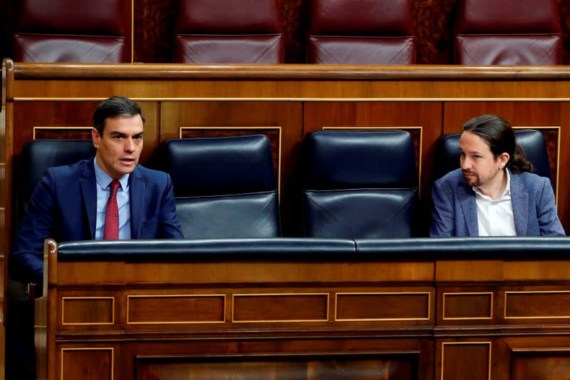 Spanish PM Sanchez paand second deputy PM Iglesias talk keeping social distancing during a session on coronavirus disease (COVID-19) at Parliament in Madrid