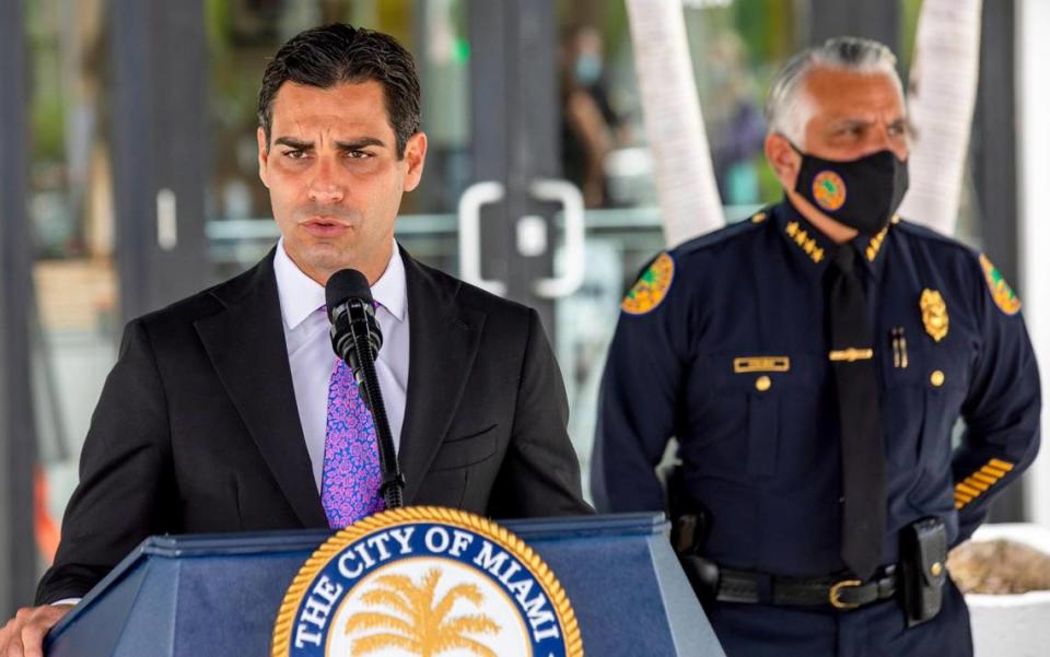 Miami Mayor Francis Suarez, with Miami Police Chief Jorge Colina behind him, discusses voter safety during a press conference at Miami City Hall on Monday, Oct. 19, 2020.