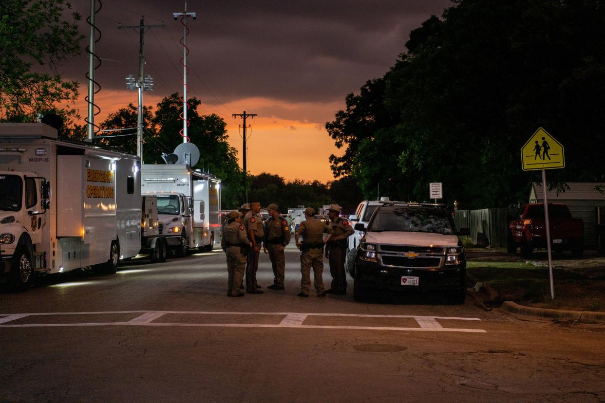 Law enforcement officers speak together outside of Robb Elementary School following the mass shooting on May 24, 2022, in Uvalde, Texas. According to reports, 19 students and 2 adults were killed, with the gunman fatally shot by law enforcement.