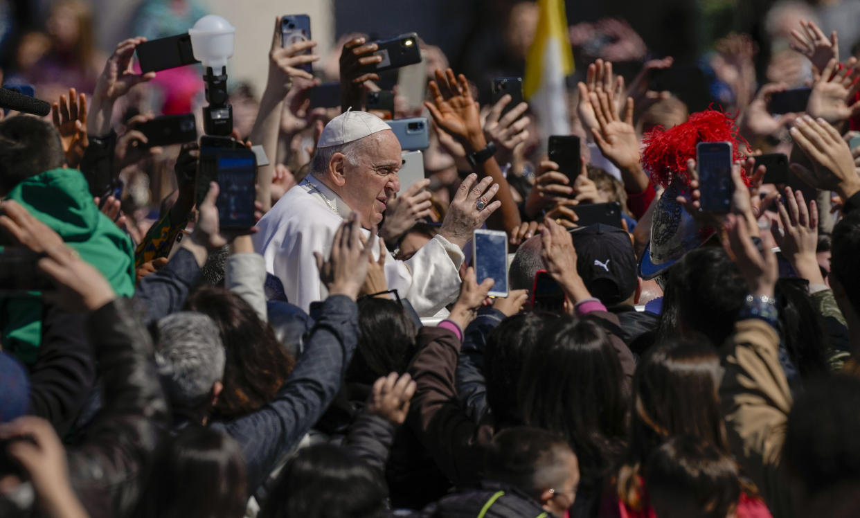 Pope Francis waves from his popemobile to the faithful gathered in St. Peter's Square at The Vatican at the end of the Easter Sunday mass, Sunday, April 9, 2023. (AP Photo/Alessandra Tarantino)
